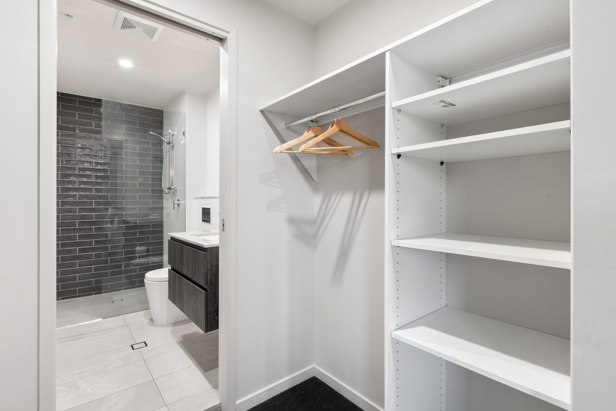 ensuite bathroom, visible through walk in wardrobe