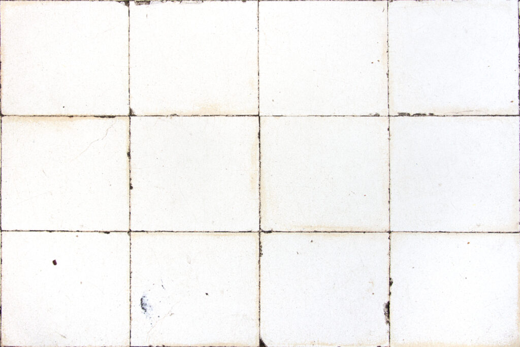 damaged and discoloured bathrom tiles, square white tiles